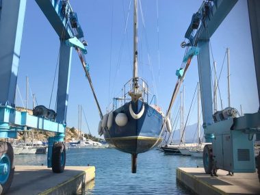 sailing boat yacht being hauled out by crane
