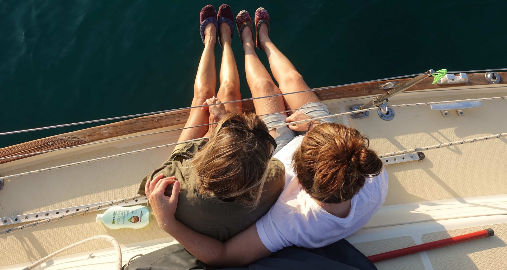 two girls having a hug on a sailing boat