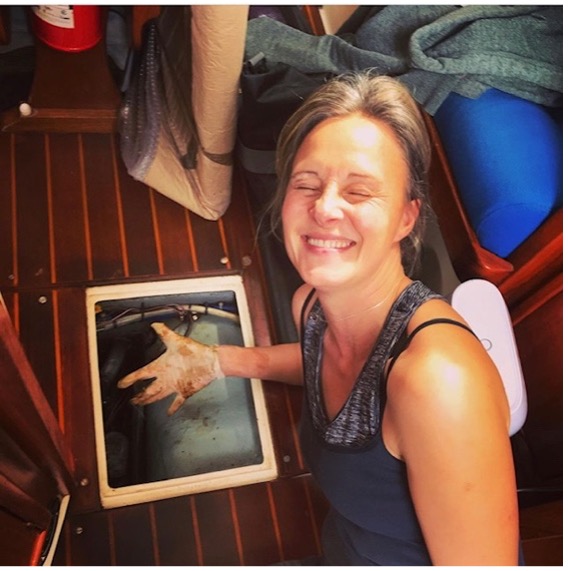person cleaning out bilges of a boat
