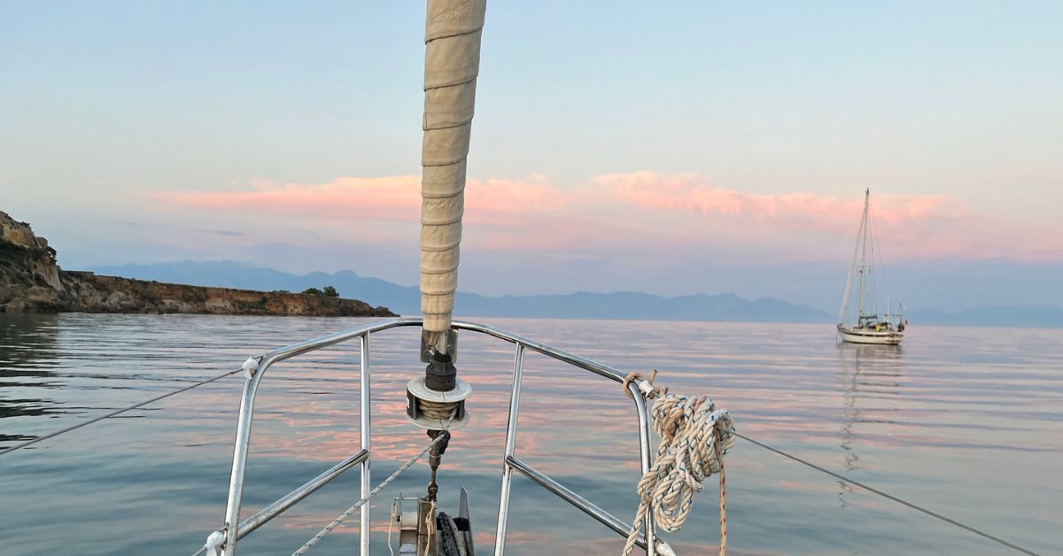 sailing boat at anchor with candyfloss coloured sunset